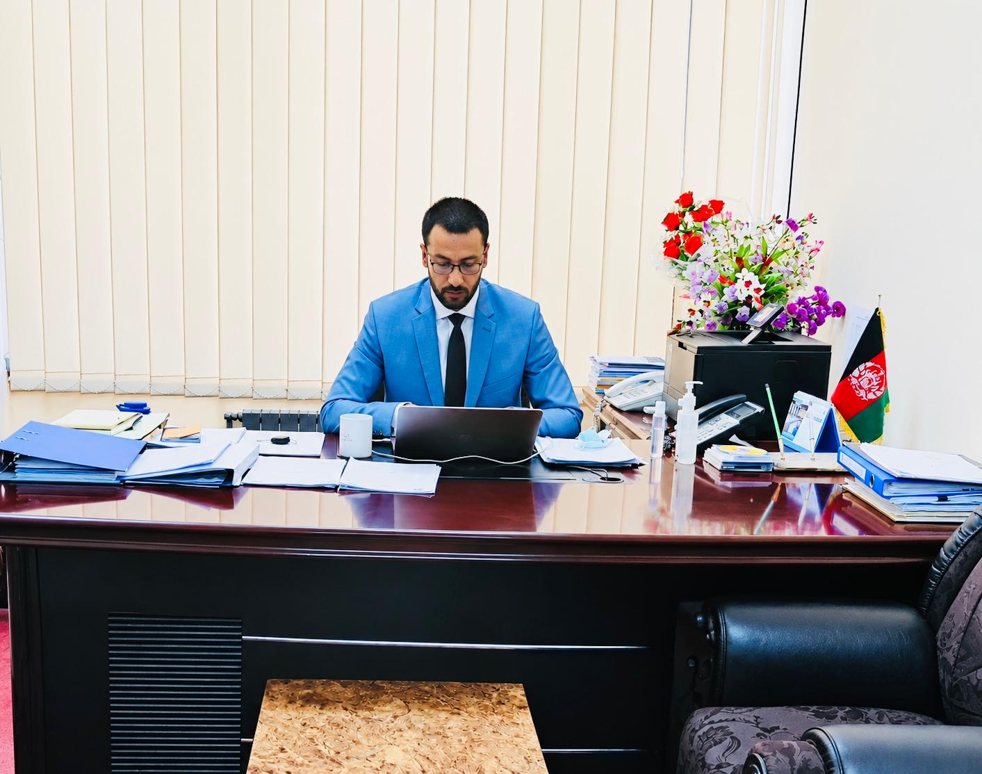 Hashmatullah Naebkhil in a professional office setting